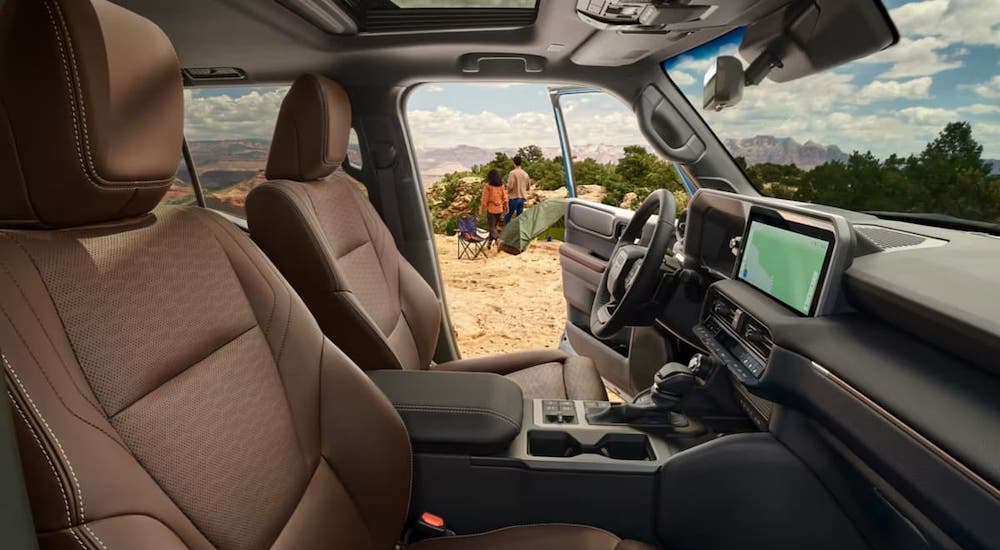 The black and brown interior of a 2024 Toyota Land Cruiser is shown.