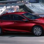 A red 2024 Chevy Malibu is shown driving.