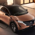 A popular electric vehicle for sale, an orange 2023 Nissan Ariya, is shown charging.