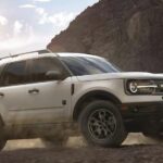 A white 2022 Ford Bronco Sport Big Bend is shown from the side while off-road.