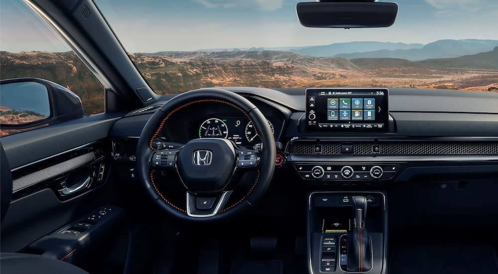 The black interior and dash of a 2023 Honda CR-V Hybrid is shown.