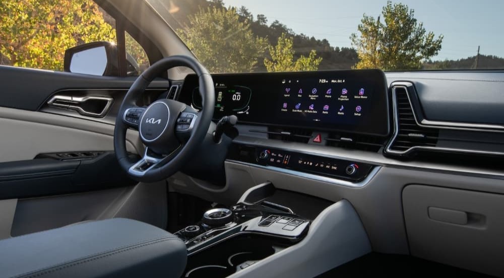 The black and gray interior and dash of a 2023 Kia Sportage Hybrid is shown.