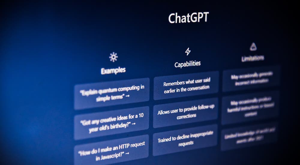 A close-up on a computer screen displaying ChatGPT's website is shown.