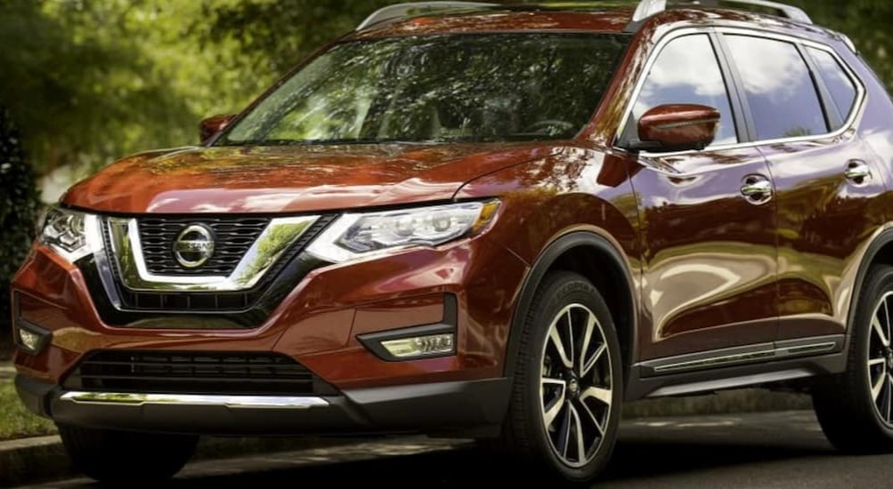 A red 2019 Nissan Rogue is shown parked on a side road.