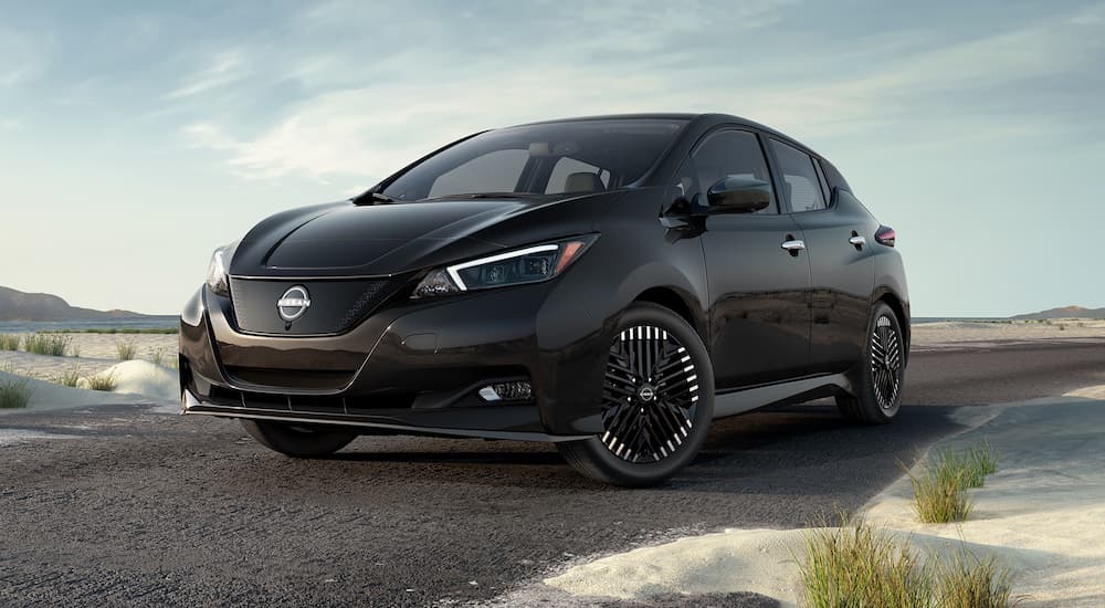 A black 2023 Nissan LEAF SV is shown driving.