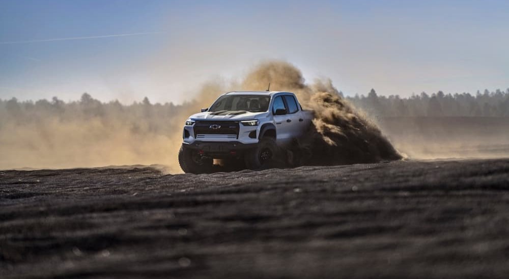 A white 2024 Chevy Colorado ZR2 Bison is shown off-roading.
