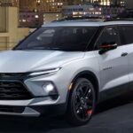 A white 2024 Chevy Blazer is shown parked on a level of a parking garage.