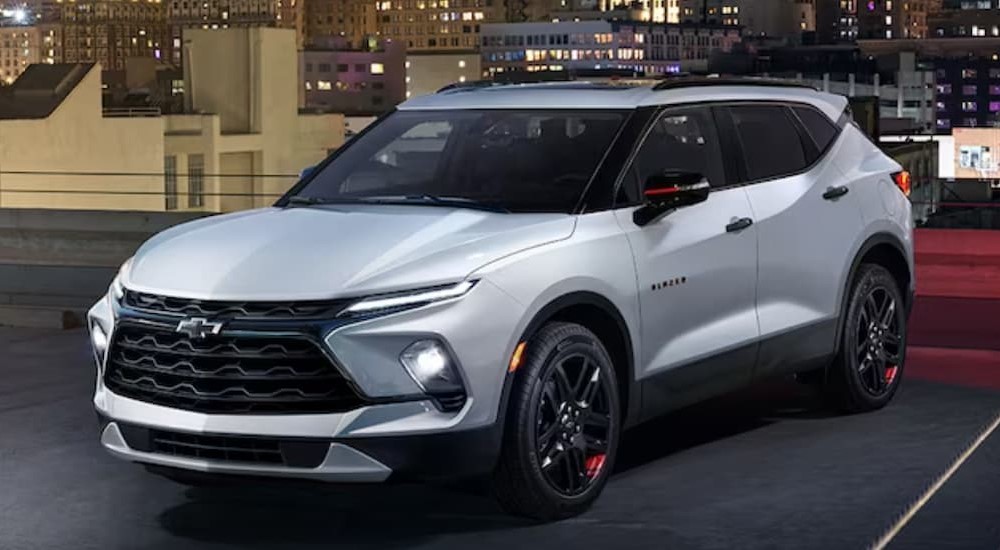 A white 2024 Chevy Blazer is shown parked on a level of a parking garage.