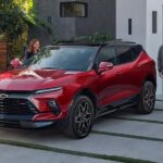 A red 2024 Chevy Blazer RS is shown parked on a driveway.