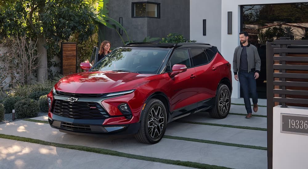 A red 2024 Chevy Blazer RS is shown parked on a driveway.