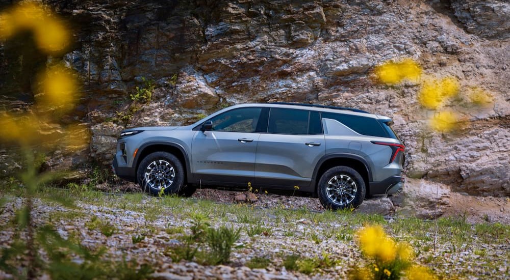 A silver 2024 Chevy Traverse Z71 is shown driving off-road after winning the 2024 Chevy Traverse vs 2023 Chevy Traverse competition.