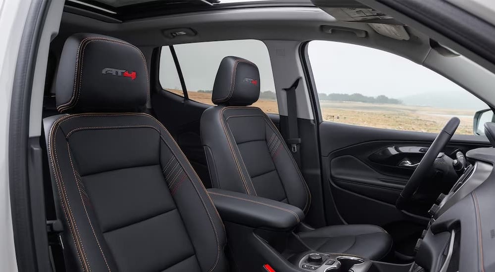 The black interior and dash of a 2024 GMC Terrain AT4 is shown.