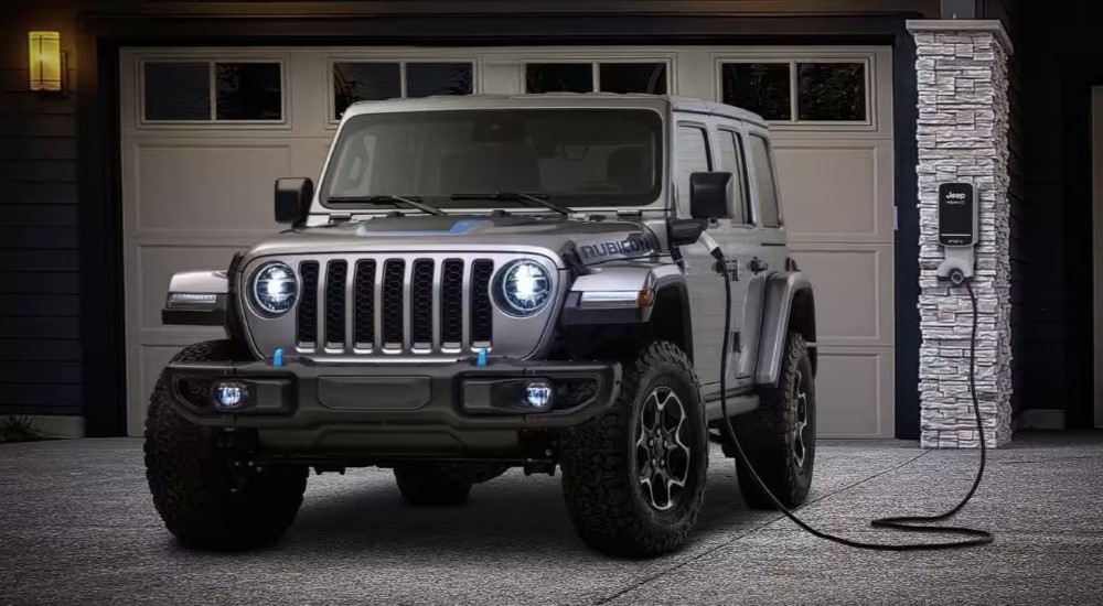 A black 2024 Jeep Wrangler 4xe Rubicon is shown charging.