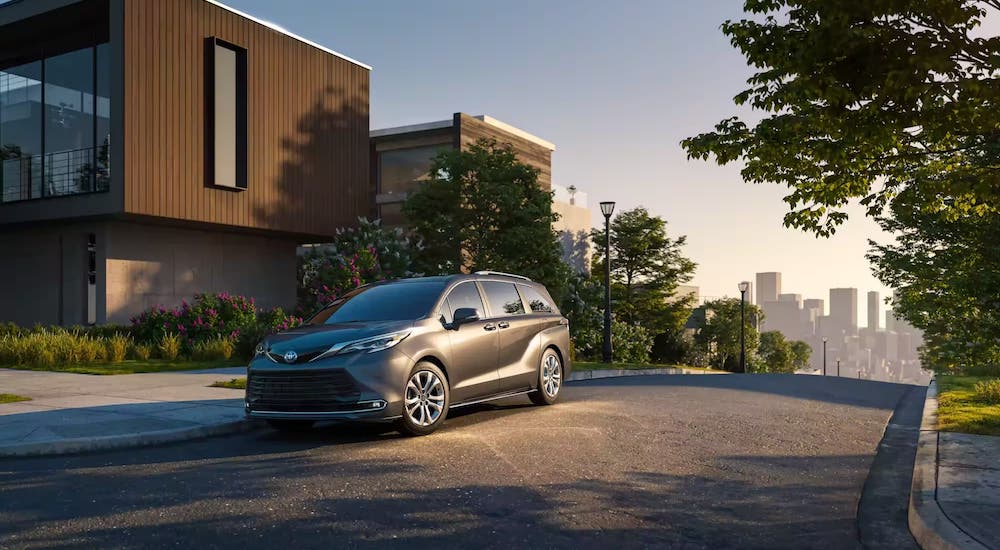 A grey 2024 Toyota Sienna is shown parked in a driveway.