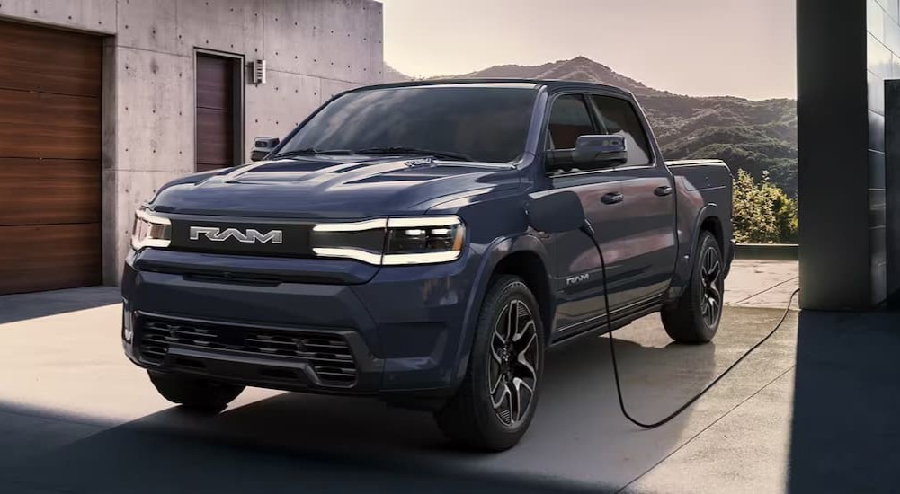 A dark blue 2025 Ram 1500 REV is shown charging after viewing electric vehicles for sale.