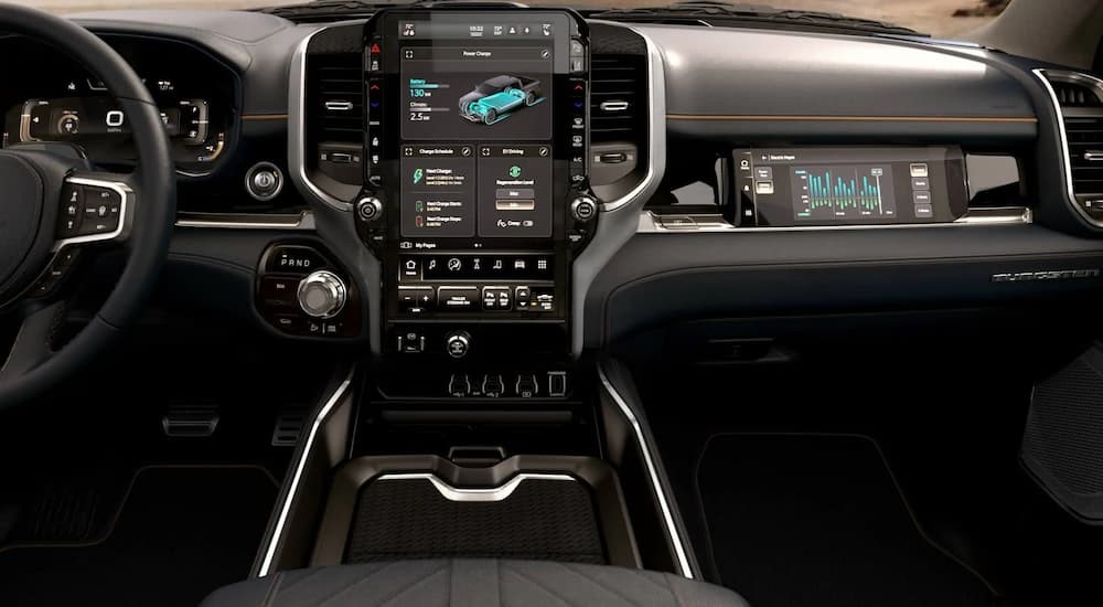 The black interior and dash of a 2025 Ram 1500 REV is shown.