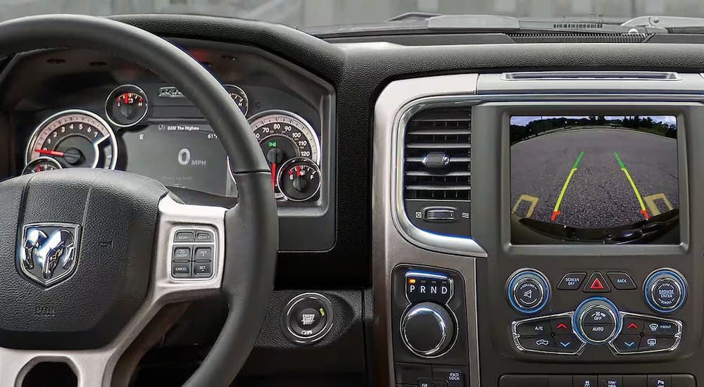A close-up on the wheel, gauges and dashboard screen of a 2023 Ram 1500 Classic is shown.