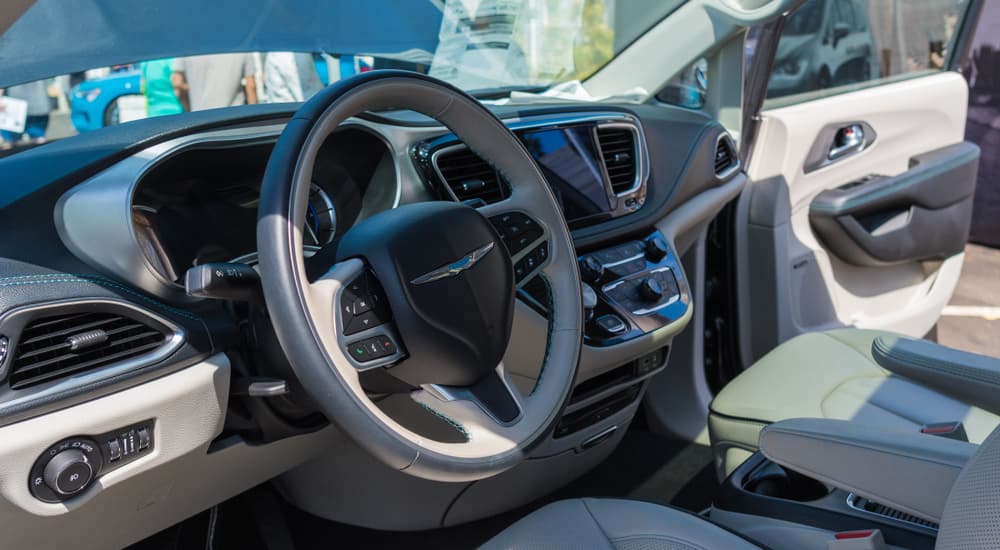 The white and black interior of a 2019 Chrysler Pacifica Hybrid is shown.