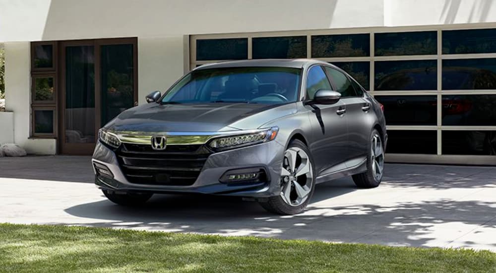 A gray 2020 Honda Accord is shown parked near a garage.