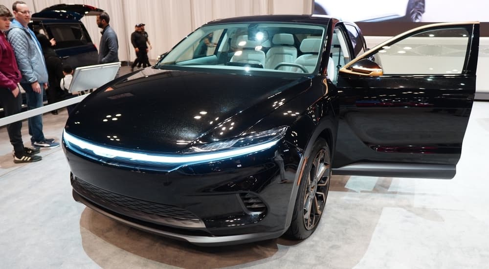 Inspired by current EVs for sale, the black 2025 Chrysler Airflow concept vehicle is shown on display at a car show.