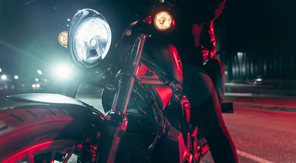 A close-up is shown of the headlamp on a black 2023 Harley-Davidson Nighster Special