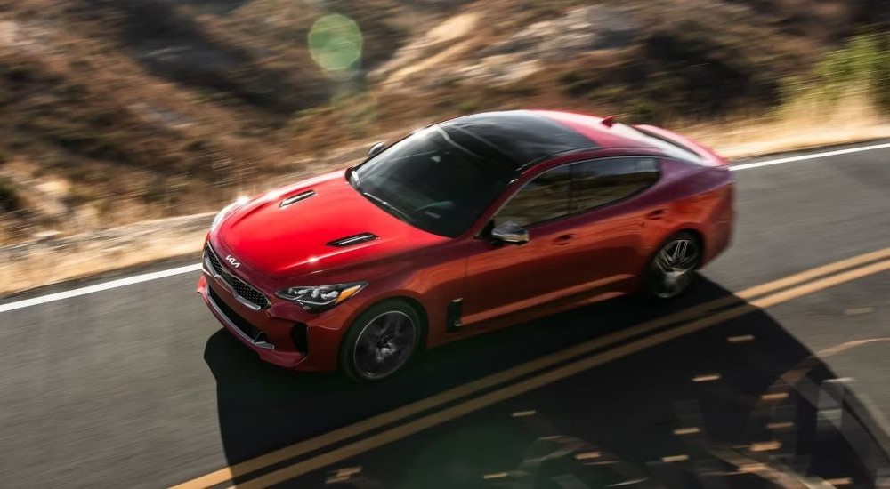 A red 2023 Kia Stinger GT is shown driving.