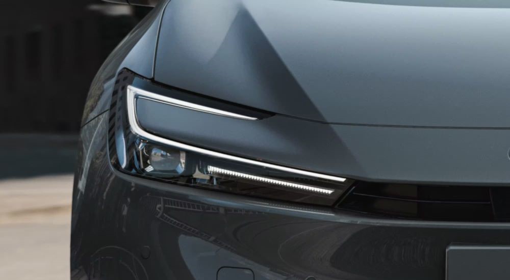 A close up shows the passenger side headlight on a grey 2023 Toyota Prius Prime XSE Premium.