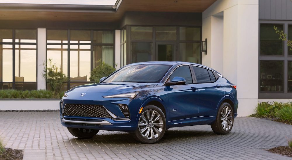 A blue 2024 Buick Envista is shown parked near a used Buick dealership.