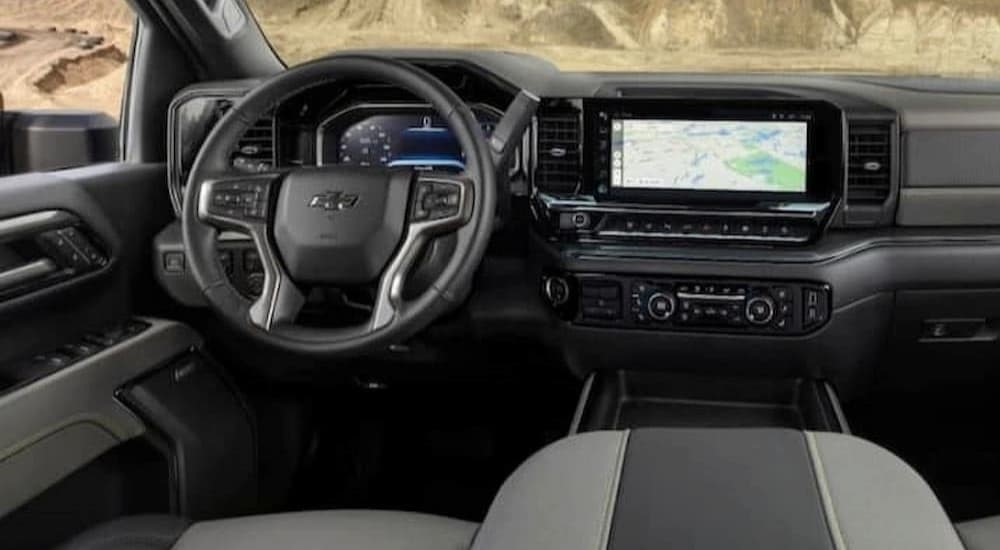 The black and gray interior and dash of a 2024 Chevy Silverado 1500 ZR2 is shown.