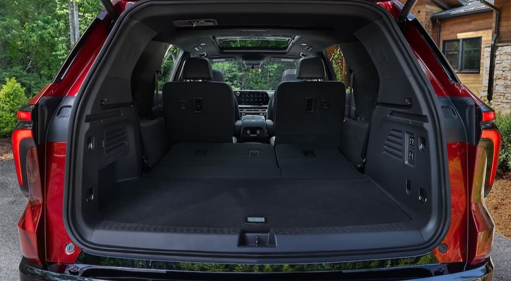 The cargo area of a red 2024 Chevy Traverse is shown.