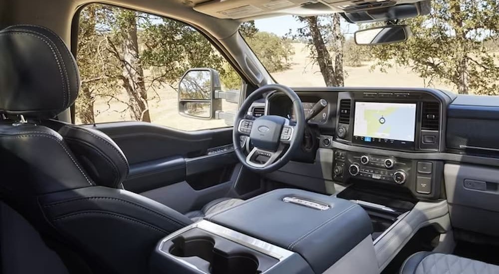 The gray interior and dash of a 2024 Ford Super Duty F-350 is shown.