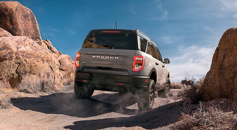 A grey 2024 Ford Bronco Sport Badlands is shown driving off-road in a desert.