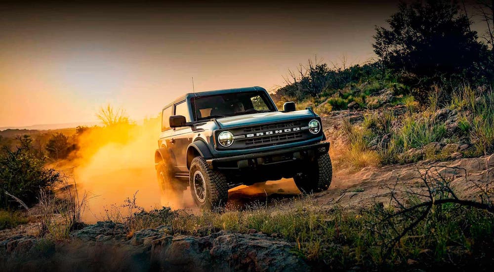 A blue 2024 Ford Bronco Sport is shown driving off-road.