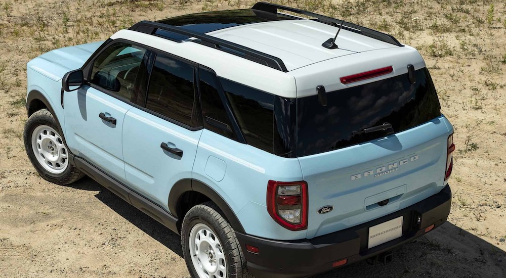 A light blue 2024 Ford Bronco Sport Heritage is shown off-roading in a desert.
