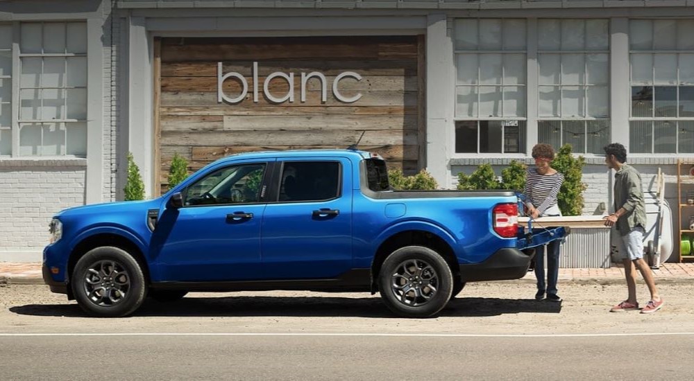 A blue 2024 Ford Maverick XLT is shown parked on a city street.