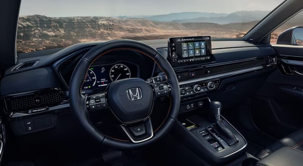 The black interior and dash of a 2024 Honda CR-V is shown.