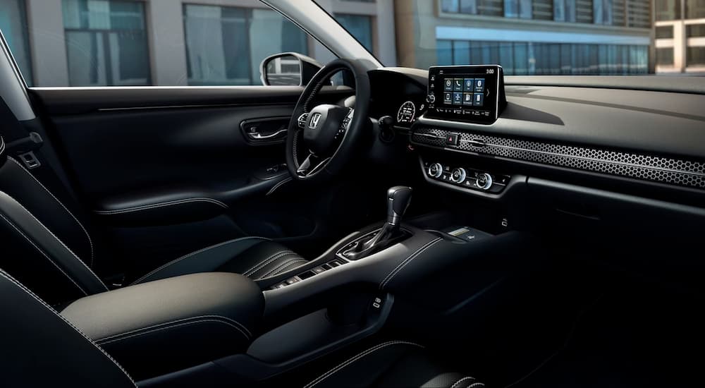 The black interior of a 2024 Honda HR-V is shown from the passenger seat.