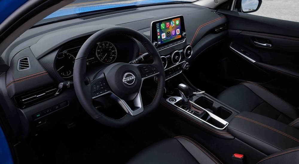 The black interior and dash of a 2024 Nissan Sentra is shown.