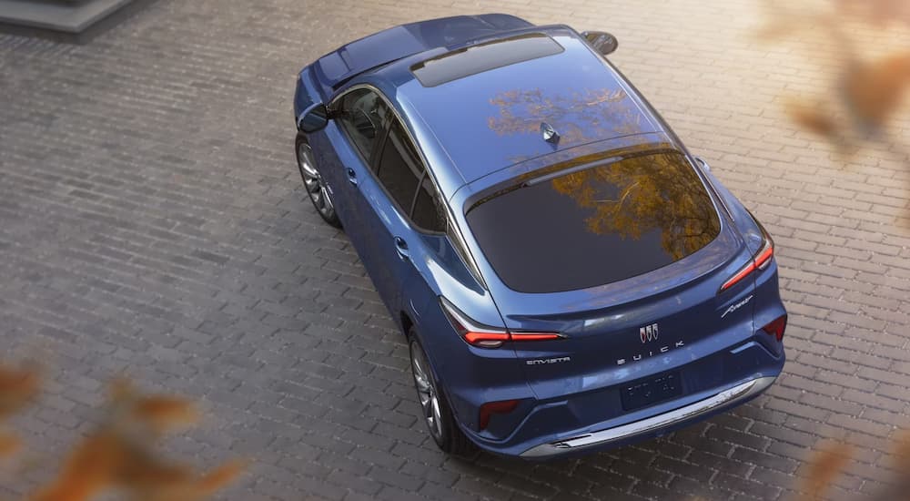 A blue 2024 Buick Envista is shown from above parked on a stone driveway.