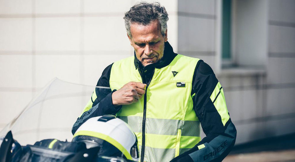 A man is shown wearing a bright yellow motorcycle jacket.