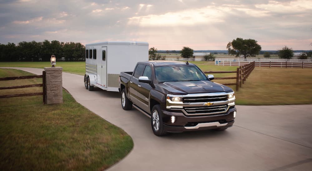 A black 2017 Chevy Silverado 1500 is shown towing a trailer.