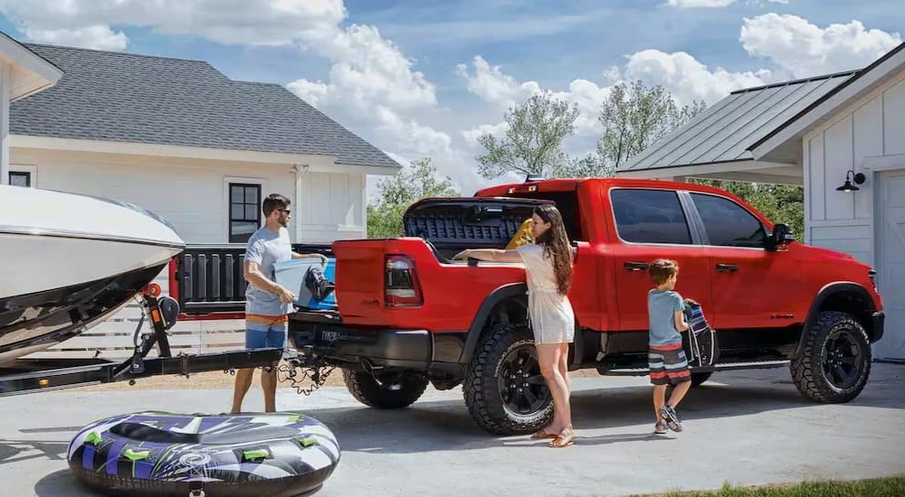 A red 2023 Ram 1500 is shown parked on a driveway.