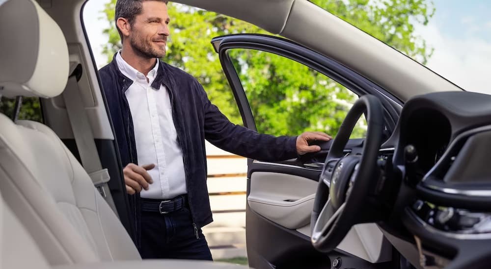 The black and white interior and dash of a 2024 Buick Enclave is shown.