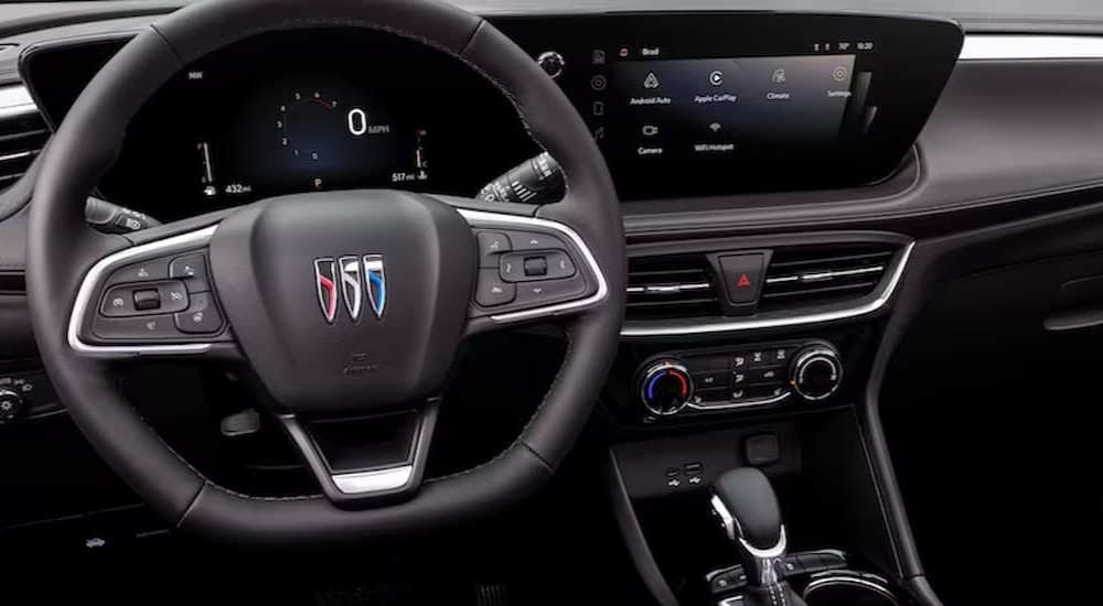 The black interior and dash of a 2024 Buick Encore GX is shown.
