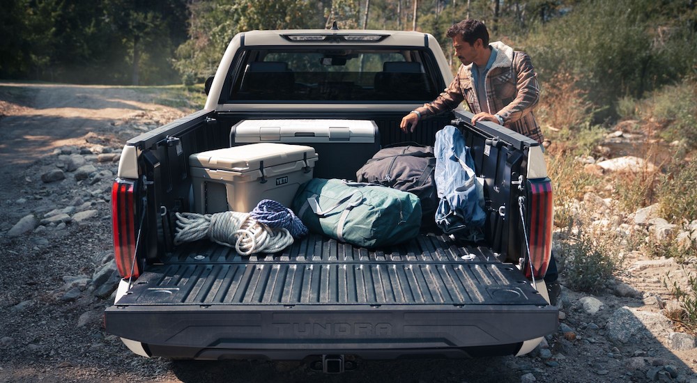 A white 2024 Toyota Tundra is shown parked near a person.