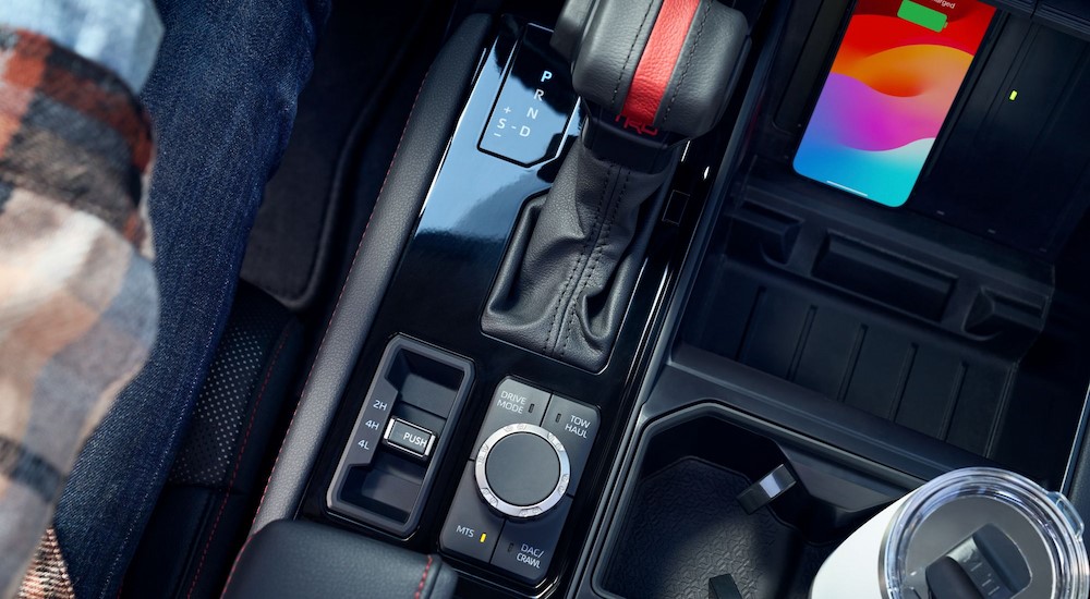 The black center console area and Multi-Terrain Select knob is shown in a 2024 Toyota Tundra.