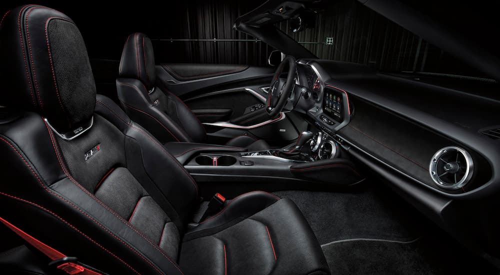 The black interior of a 2024 Chevy Camaro ZL1 is shown from the passenger seat.