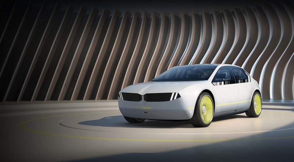 One of many popular favorite concept cars from 2023, a silver 2023 BMW i Vision Dee Concept, is shown parked.