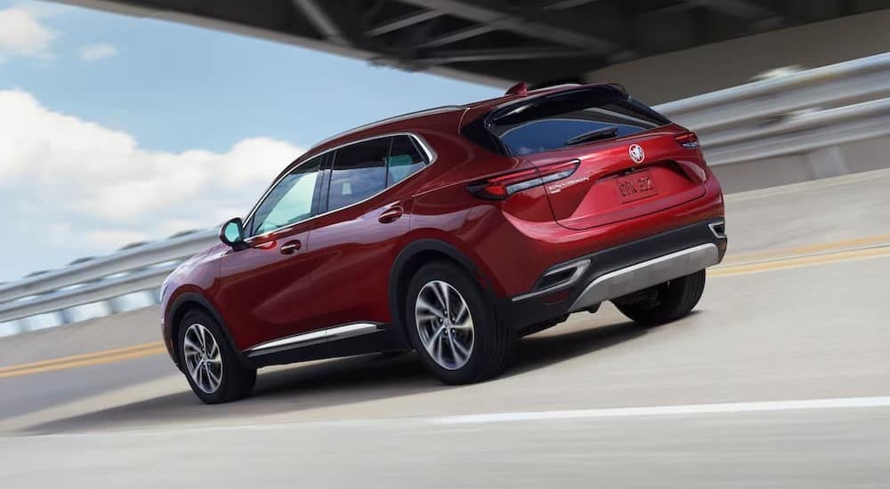 A red 2023 Buick Envision is shown driving.