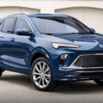 A blue 2024 Buick Encore GX is shown parked on a driveway after visiting a Buick dealer.